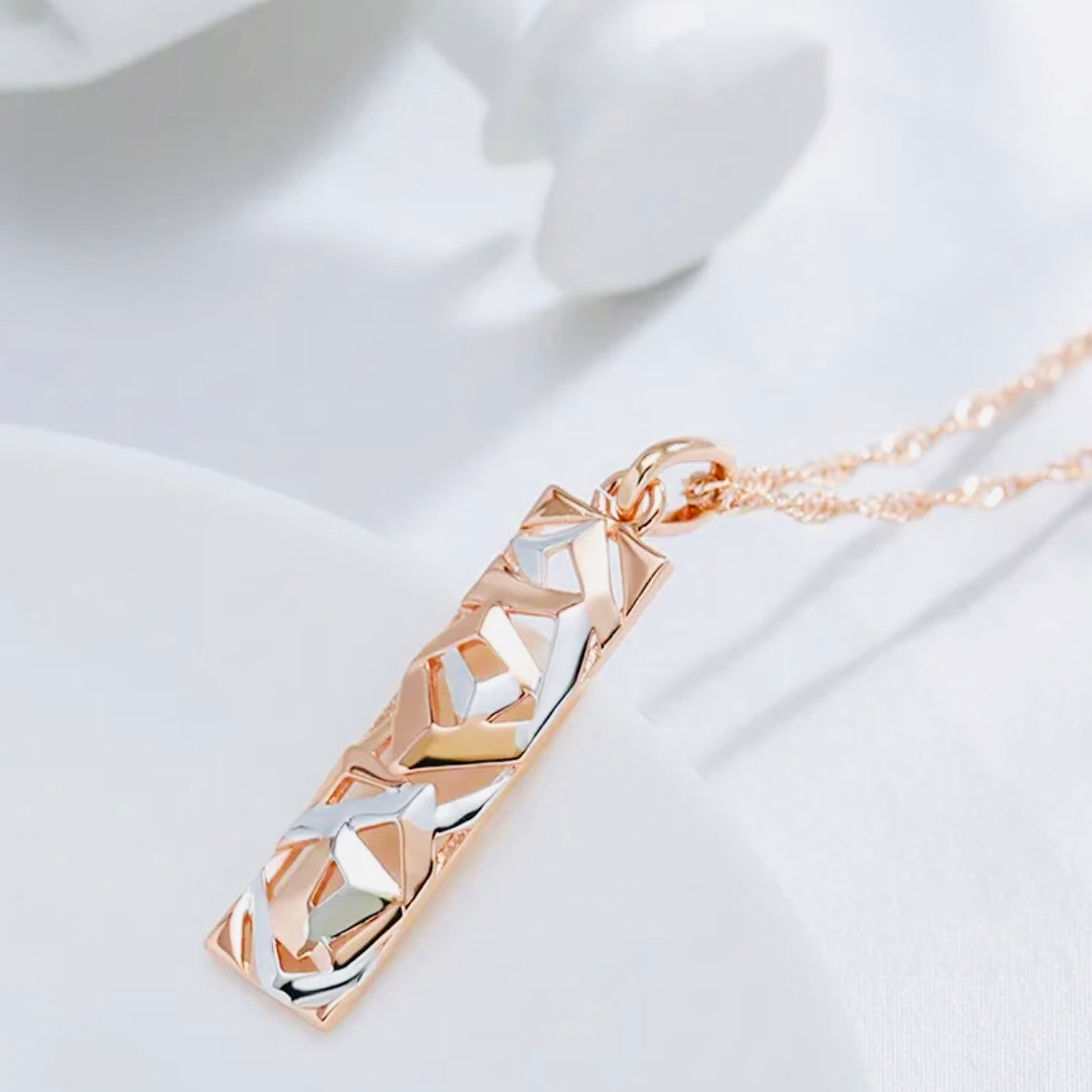 This Sterling Silver, Rose Gold, and High-grade Steel tricolor necklace and earrings set is perfect for any special woman in your life. Crafted with expertly sourced top-grade steel and silver material, these pieces are timeless and sure to make a lasting impression. The pendant is a twisted-rectangle shape adorned with dazzling sparkles, while the 18-inch link-style necklace complements with a bold yet elegant look. Matching tricolor earrings complete the set - perfect for any occasion!