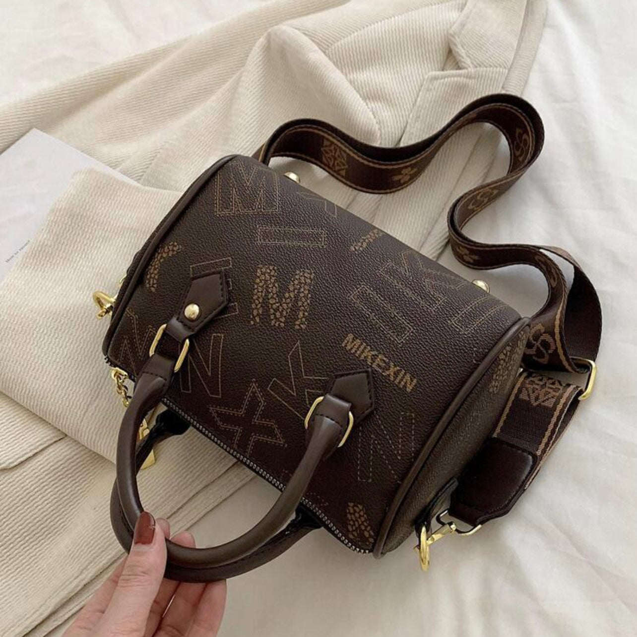 Designer leather vintage cross body adjustable coffee brown handbag with zipper gold accents and letter pattern style considered a “Boston bag” comes with a long adjustable removable matching straps and handles for adjustable convenience. This bag is only available at LadiesNGentz.com and also At Facetreasures Boutique at facetreasures.com debut for the first time on LadiesNgentz on Black Friday November 2023