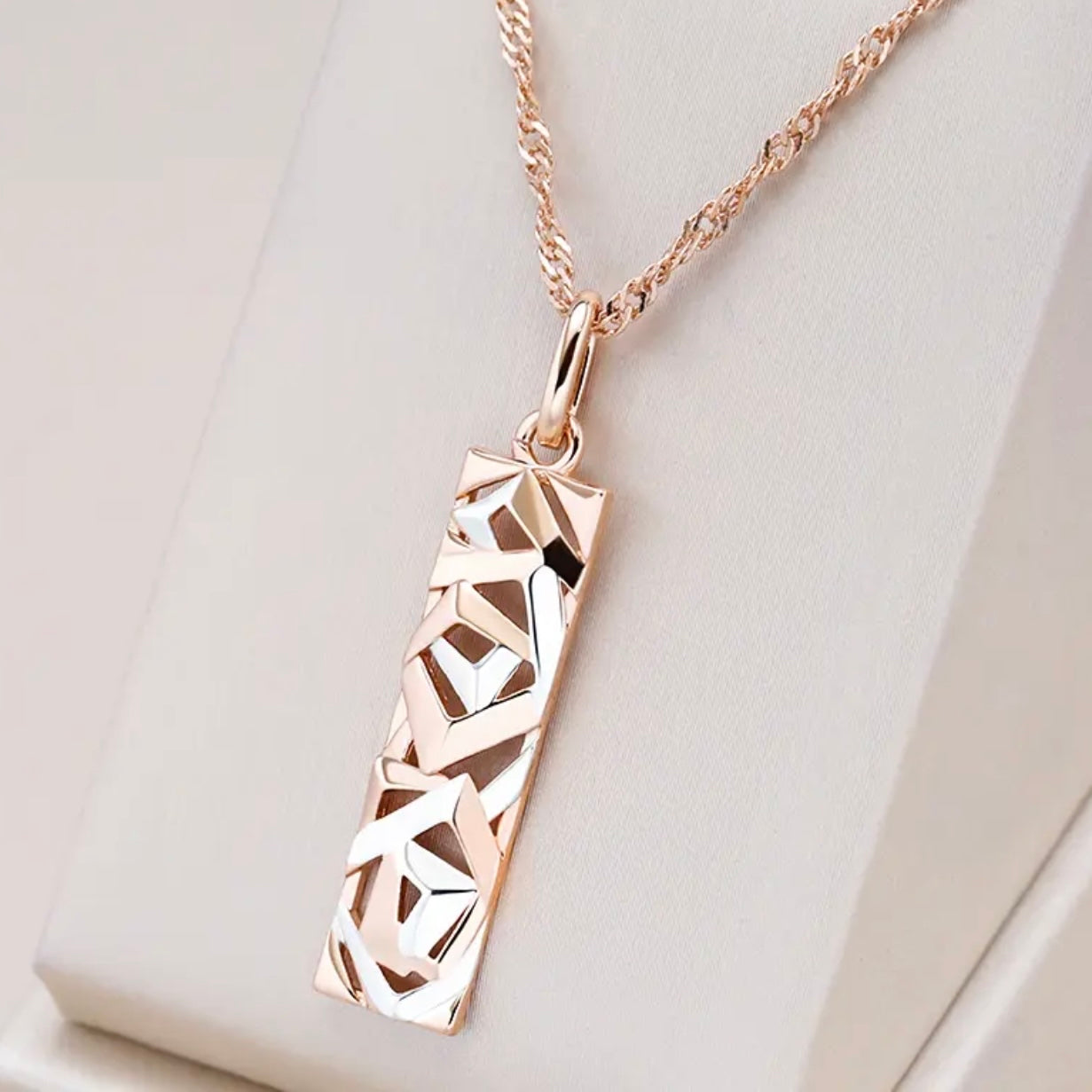 This Sterling Silver, Rose Gold, and High-grade Steel tricolor necklace and earrings set is perfect for any special woman in your life. Crafted with expertly sourced top-grade steel and silver material, these pieces are timeless and sure to make a lasting impression. The pendant is a twisted-rectangle shape adorned with dazzling sparkles, while the 18-inch link-style necklace complements with a bold yet elegant look. Matching tricolor earrings complete the set - perfect for any occasion!