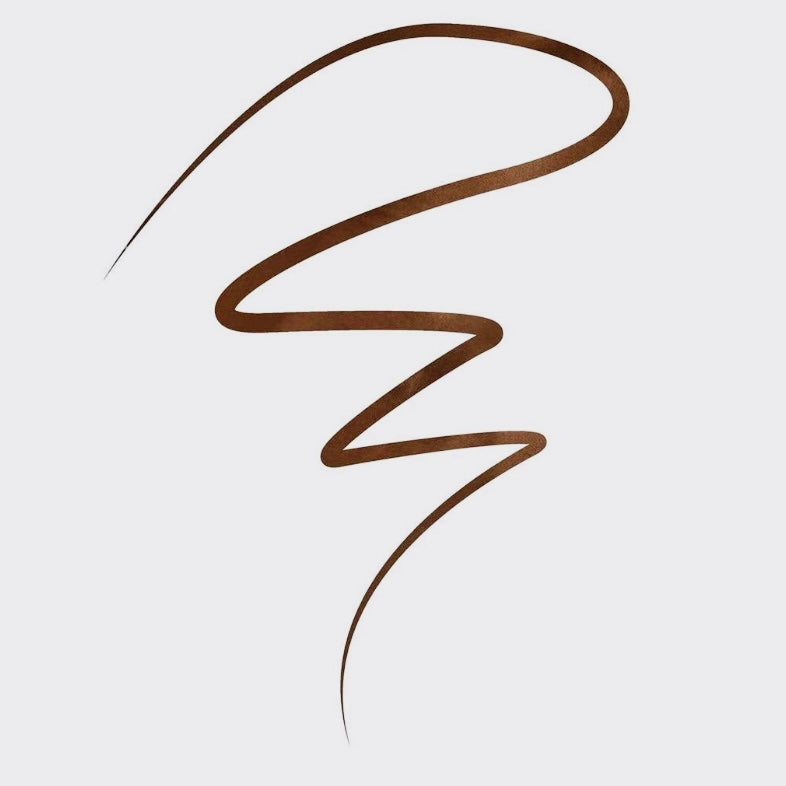 Eyeko London Black Magic: Cocoa Edit Liquid Eyeliner in the color “Brown” is a warm brown liquid eyeliner felt tip pen that can be worn on the waterline or smoked out into the lash line. It can also be used as an eyeshadow base. This eyeliner is waterproof, has a deep high pigment color payoff that will last as long as you need it too. This Liquid Eyeliner has a precision brush tip inspired by traditional Japanese calligraphy and gives you the most precise perfect lines with ease.