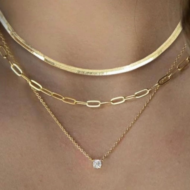 Layered Gold Necklaces: 3-Piece 14K Vermeil Gold over solid 925. Silver necklace set for Women, this set includes one 16 inch clavicle herringbone 14 karat vermeil gold necklace, one 17 inch paperclip style 14 karat Vermeil gold & one 18inch necklace with a 1 carat total weight of flawless princess cut cubic zirconia pendant. All 3 are beautiful worn as a layered style or can be worn separately. Only available for purchase at Facetreasures.com