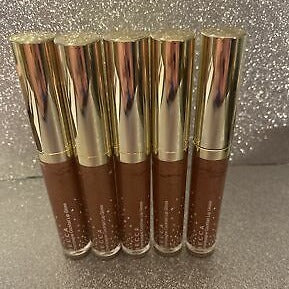 This Lip Gloss Is A very warm-toned, light-medium Tan (Soft Brown) with a hint of Peach pearl finish. It is a sheer lip-gloss that not sticky and goes on smooth and with ease. The 3D light-reflecting pigments as well as Ginger, Peppermint oil, and a non-stinging peptide make lips appear fuller and smoother. Contains Vitamins C and Vitamin E, plus hydrating Shea Butter and Muru Muru Butters to soften, protect and condition the lips. Becca Champagne Cocktail Lip Gloss shade "Bellini"