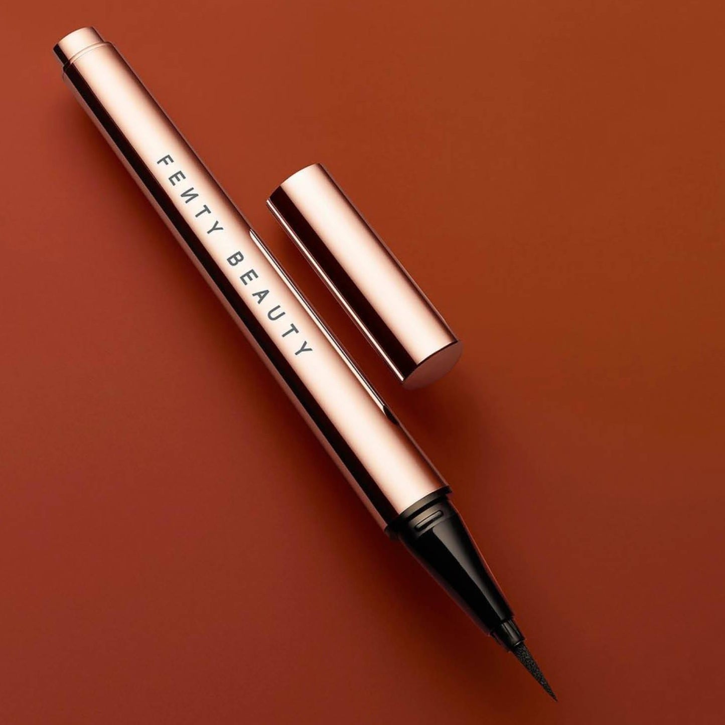 Fenty fly liner liquid eyeliner in the color "cuz I'm black" satin black color, A hyper-saturated, water-resistant liquid eyeliner with an innovative flex tip and easy-grip triangle shape for effortless no-limit lining that lasts.