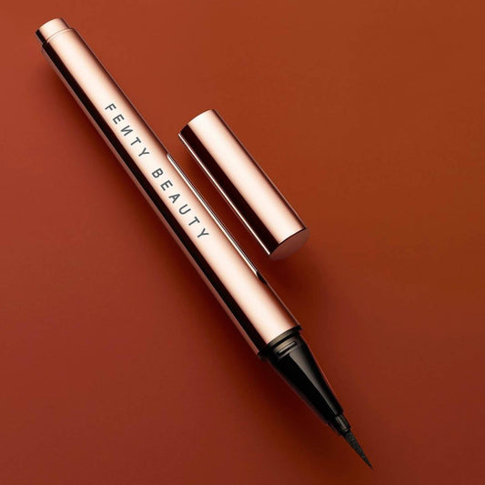 Fenty fly liner liquid eyeliner in the color "cuz I'm black" satin black color, A hyper-saturated, water-resistant liquid eyeliner with an innovative flex tip and easy-grip triangle shape for effortless no-limit lining that lasts.