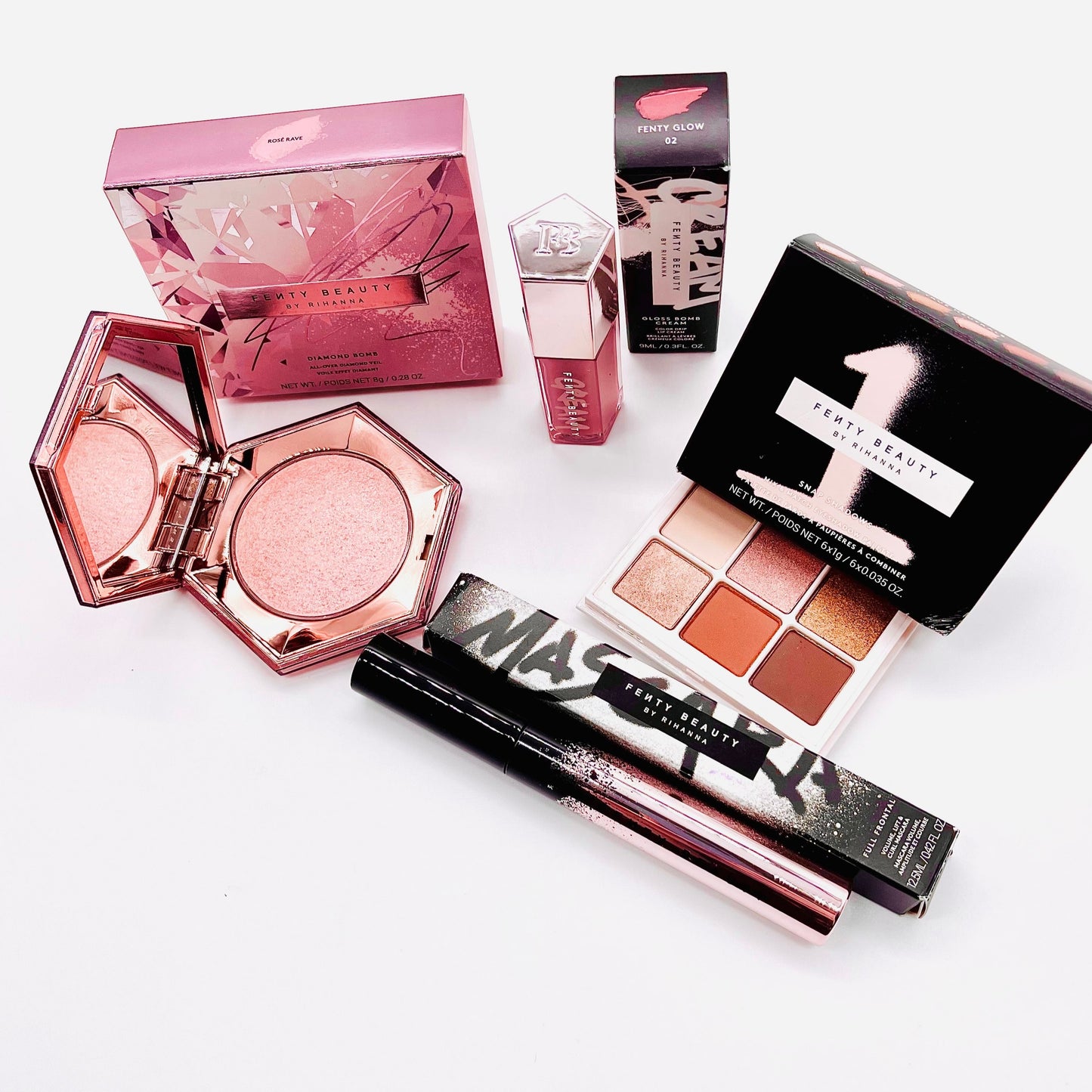 fenty beauty 4 piece designer beauty makeup set which includes mascara, lip gloss, eyeshadow and a highlighter