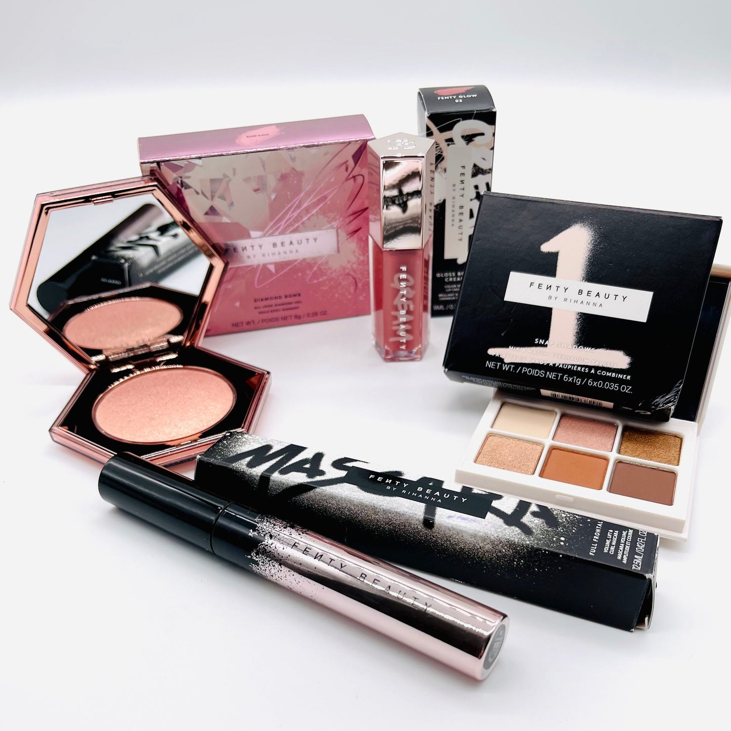 fenty beauty 4 piece designer beauty makeup set which includes mascara, lip gloss, eyeshadow and a highlighter