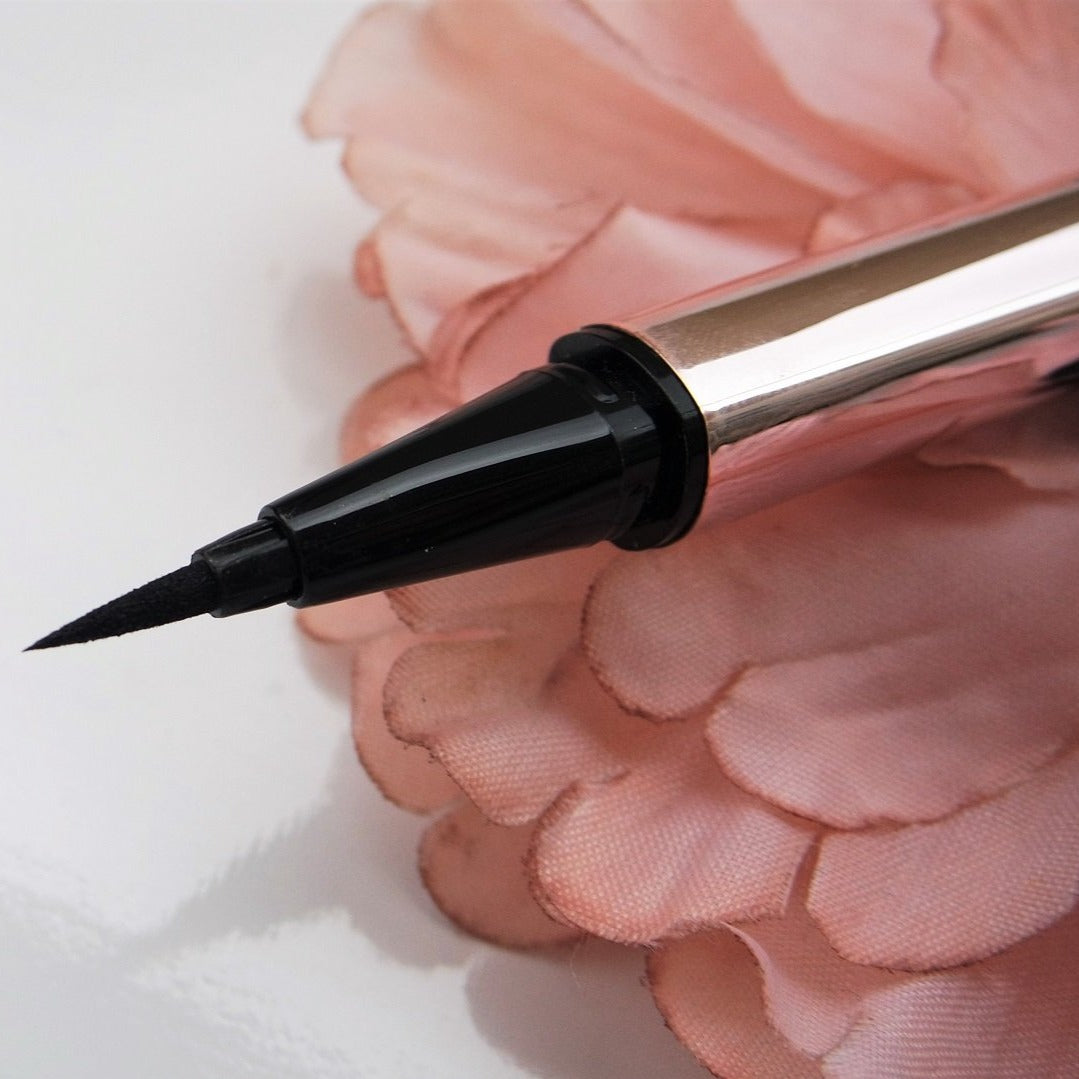 Fenty fly liner liquid eyeliner in the color "cuz I'm black" satin black color, A hyper-saturated, water-resistant liquid eyeliner with an innovative flex tip and easy-grip triangle shape for effortless no-limit lining that lasts.