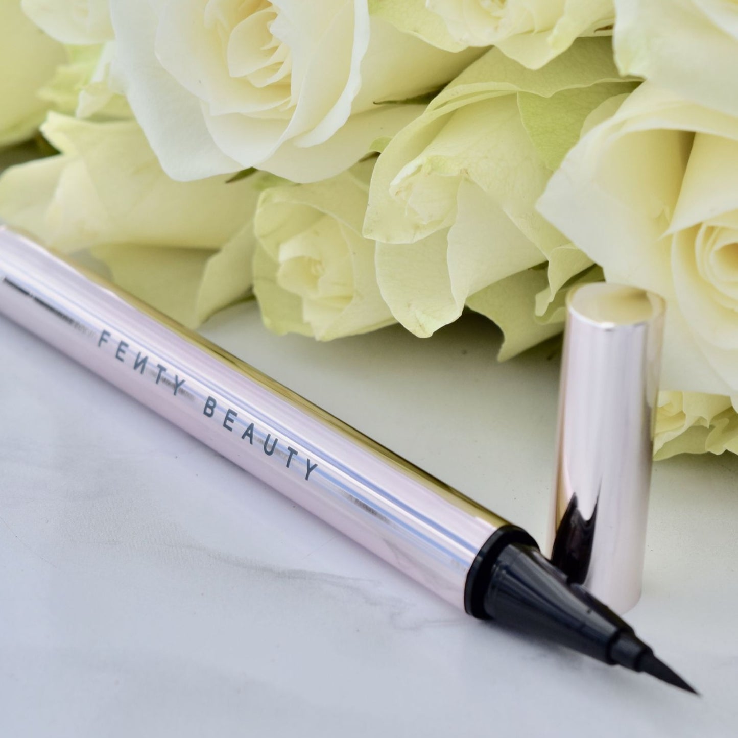 Fenty fly liner liquid eyeliner in the color "cuz I'm black" satin black color, A hyper-saturated, water-resistant liquid eyeliner with an innovative flex tip and easy-grip triangle shape for effortless no-limit lining that lasts.