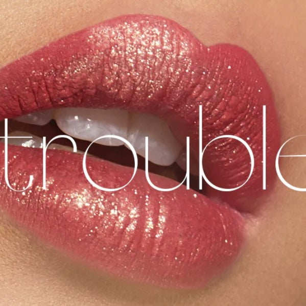 Model is showing her lips wearing the ciate glitter flip liquid lipstick in the color “trouble”