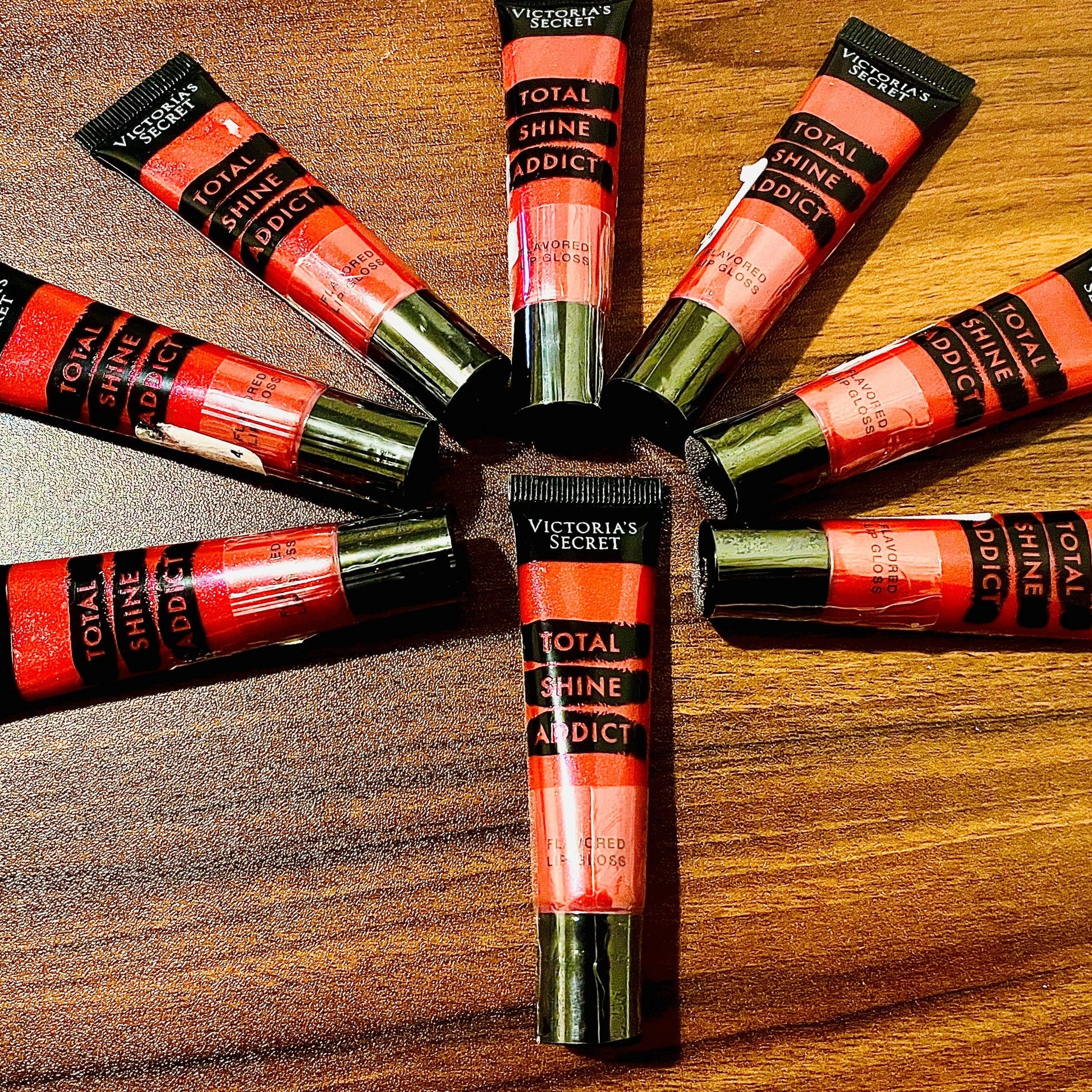 This photo shows 8 victoria secret total shine addict lip glosses with some sale sticker residue on the items as these products were marked down in price due to being unable to remove some sale stickers without damaging the safety seal so we opted to sell the items discounted with the stickers to keep the safety seal in tact.on all the products. & marked the products down drastically. all products are brand new unused with minor cosmetic imperfections on outer packaging