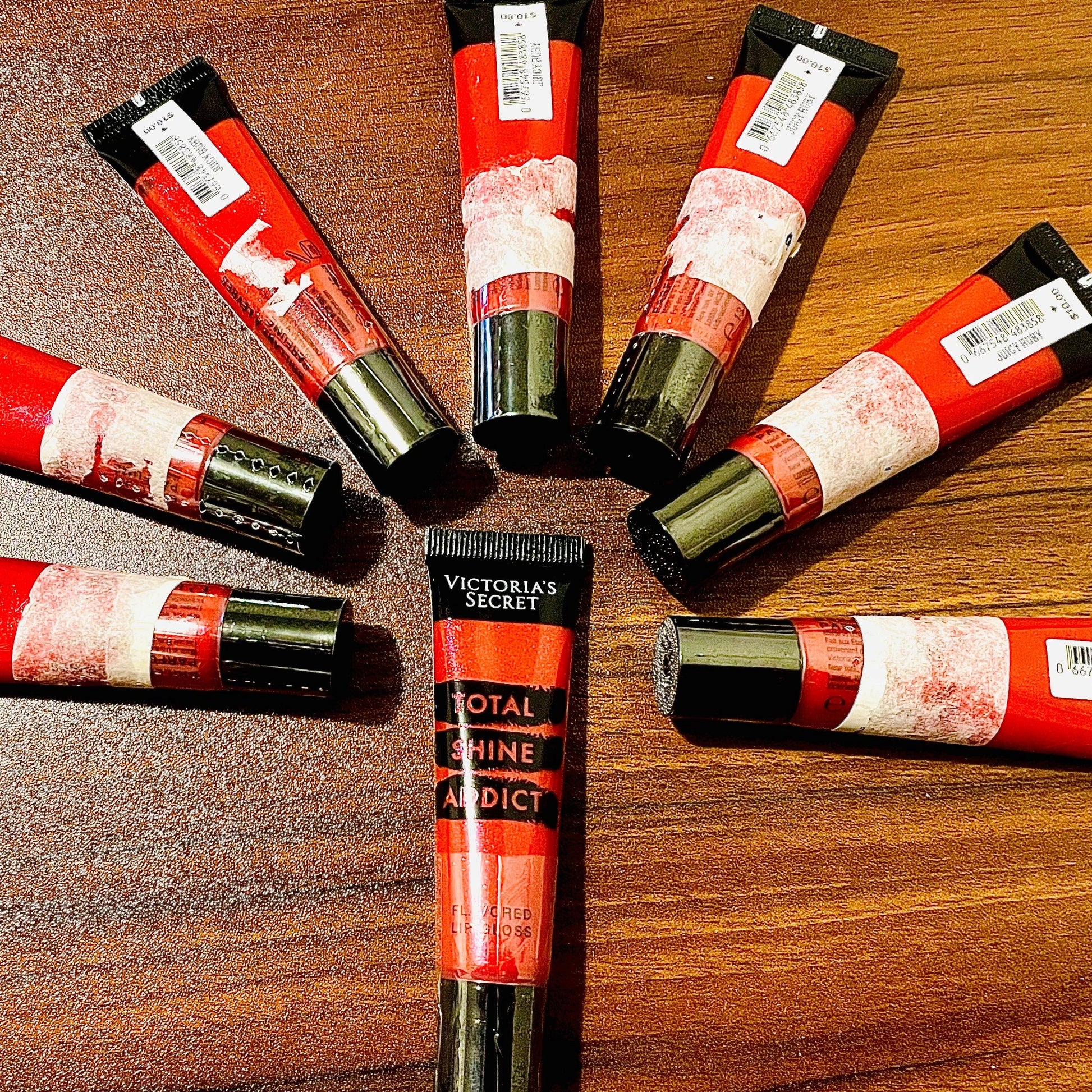 This photo shows 8 victoria secret total shine addict lip glosses with some sale sticker residue on the items as these products were marked down in price due to being unable to remove some sale stickers without damaging the safety seal so we opted to sell the items discounted with the stickers to keep the safety seal in tact.on all the products. & marked the products down drastically. all products are brand new unused with minor cosmetic imperfections on outer packaging