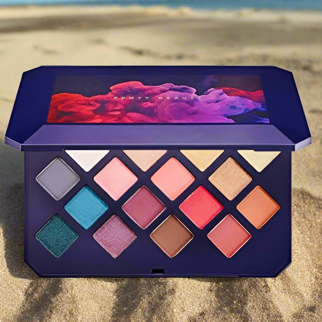 Fenty beauty limited edition, 16 color, Moroccan eyeshadow palette with mirror, made by Grammy award-winning, singer & songwriter “Rihanna” this photo is showing the palette open displaying all 16 eyeshadow colors while sitting in the beach sand This moroccan eyeshadow palette is no longer in production or being manufactured, it is rare and very limited in supply but high in demand.