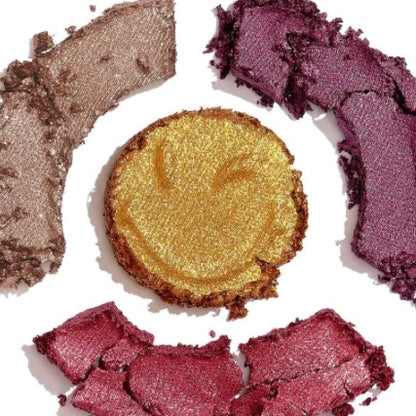 Eyeshadows crushed on an all white background show casing the pigments and quality of the eyeshadow colors