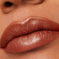 Lady wearing Estée Lauder Pure color Envy Limited Edition Lip sculpting lipstick in the color #111 Tiger Eye