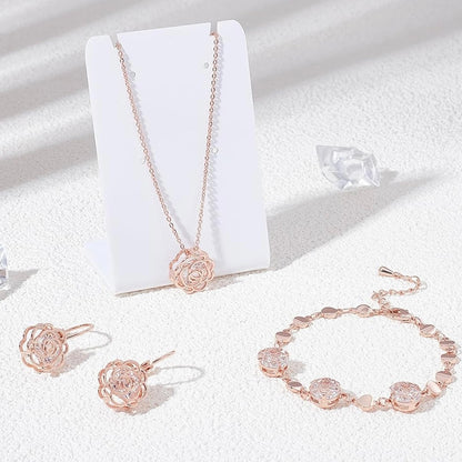 Rose gold jewelry set including necklace, earrings, and bracelet on a white background