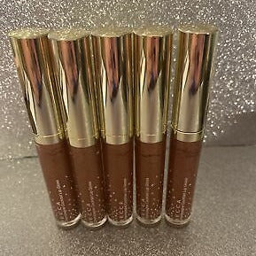 This Lip Gloss Is A very warm-toned, light-medium Tan (Soft Brown) with a hint of Peach pearl finish. It is a sheer lip-gloss that not sticky and goes on smooth and with ease. The 3D light-reflecting pigments as well as Ginger, Peppermint oil, and a non-stinging peptide make lips appear fuller and smoother.  Contains Vitamins C and Vitamin E, plus hydrating Shea Butter and Muru Muru Butters to soften, protect and condition the lips. Becca Champagne Cocktail Lip Gloss shade "Bellini" 