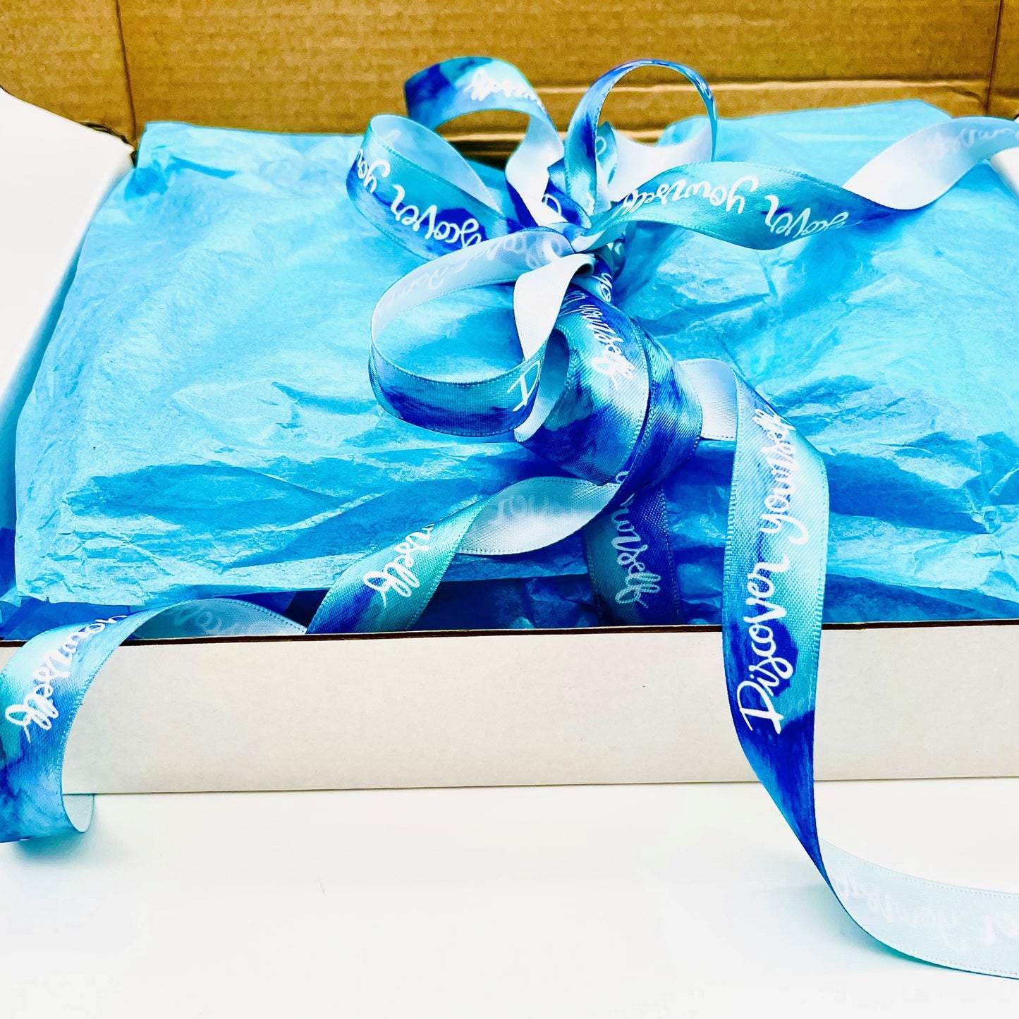 A Free Blue Gift Box With Matching Ribbon With All Orders