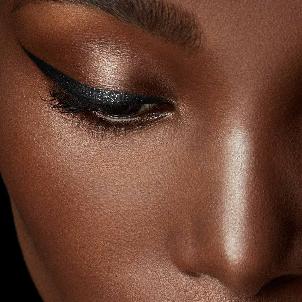Fenty fly liner liquid eyeliner in the color "cuz I'm black" satin black color, A hyper-saturated, water-resistant liquid eyeliner with an innovative flex tip and easy-grip triangle shape for effortless no-limit lining that lasts.