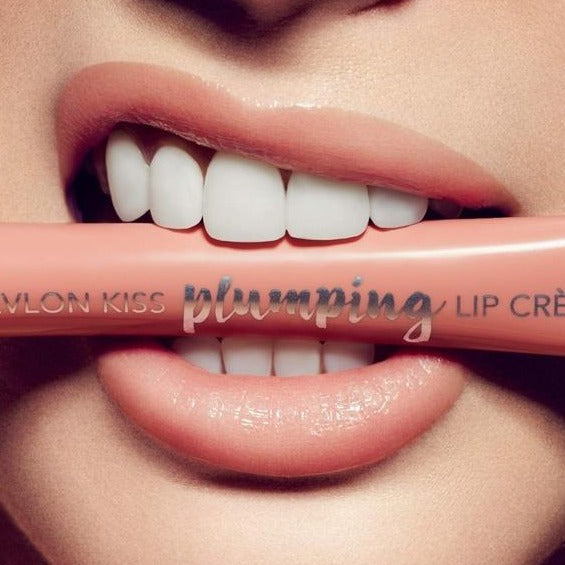 Person biting down on a Revlon's Kiss Plumping Lip Crème lipstick in the color#520 Fresh Pastel