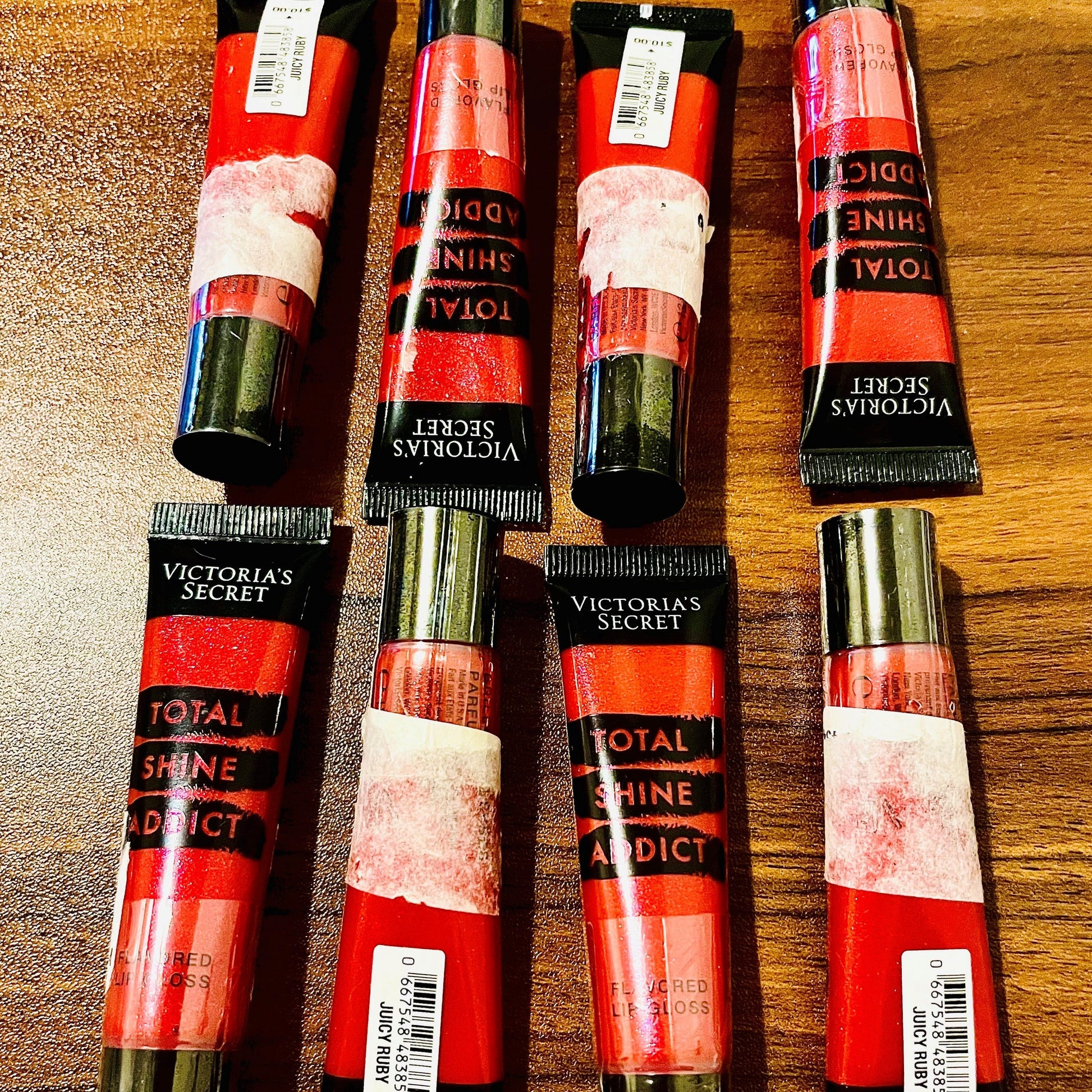 This photo shows 8 victoria secret total shine addict lip glosses with some sale sticker residue on the items as these products were marked down in price due to being unable to remove some sale stickers without damaging the safety seal so we opted to sell the items discounted with the stickers to keep the safety seal in tact.on all the products. & marked the products down drastically. all products are brand new unused with minor cosmetic imperfections on outer packaging